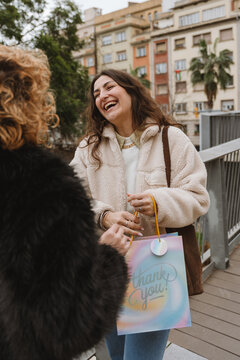Two female friends giving gift during a birthday celebration