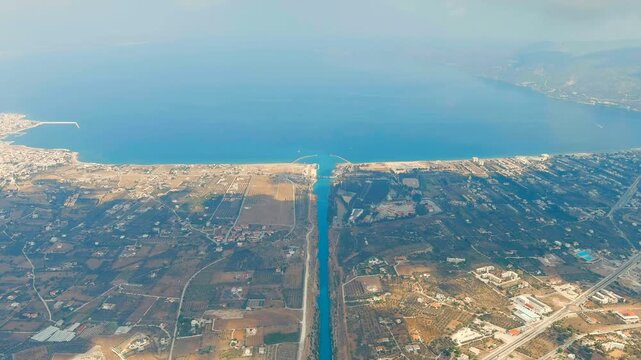Corinth Canal, Greece. The Corinth Canal is a sluiceless shipping canal in Greece, connecting the Saronic Gulf of the Aegean and the Gulf of Corinth of the Ionian Sea. Drone footage