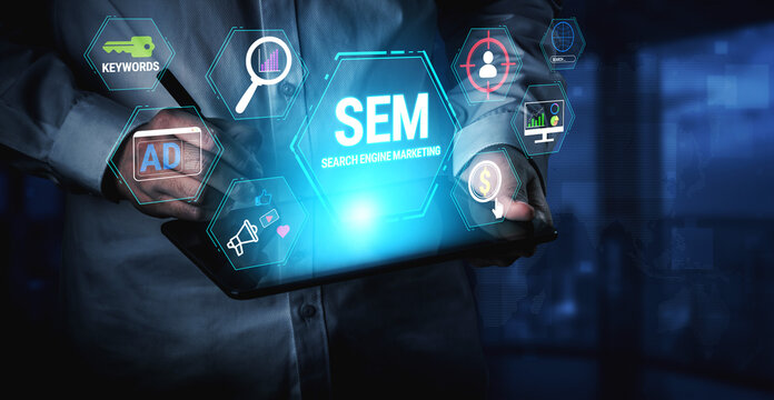 Professional engaging with digital marketing concepts focused on search engine marketing, emphasizing ads, keywords, and analytics in a modern workspace. Fluxor.