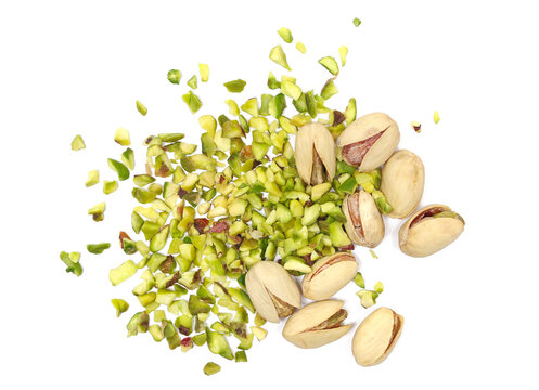 Pistachios chopped pile with nutshell isolated on white background, top view