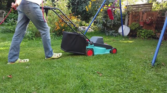 Mowing the lawn with an electric lawnmower