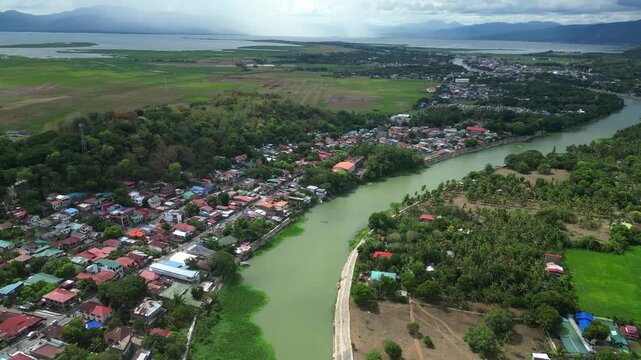 Aerial drone view of Pagsanjan Municipality in Laguna Province, Philippines showing the historic river town, Pagsanjan River (Bumbungan River), residential areas, and the Sierra Madre foothills of Eas