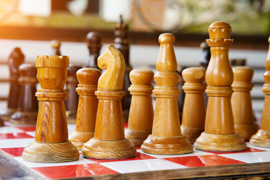 large wooden chess pieces on the board