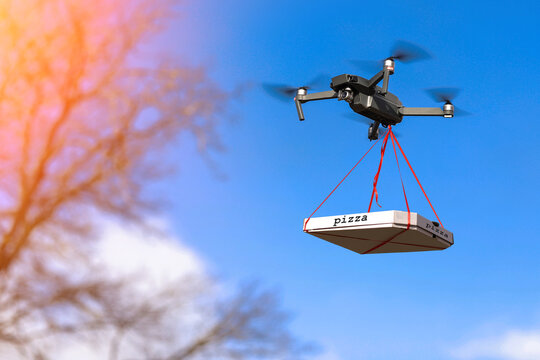 DRONE IS FLYING WITH A PIZZA