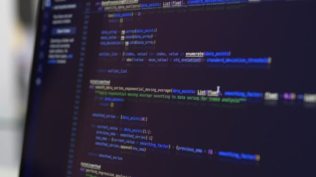 Dark laptop screen with vivid blue and green code syntax in close shot showing hacker aesthetic programming. Vibe coding night and cybersecurity developer screen concept.