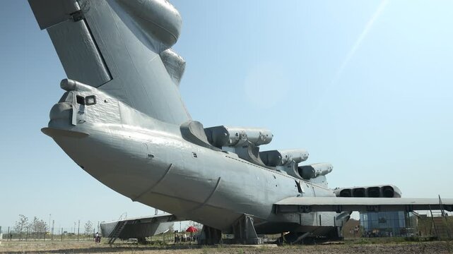 August 8, 2020, Derbent, Russia. Project 903 Lun ekranoplan missile ship. A large airplane sits on a grass-covered field, suitable for rural airport or agricultural use
