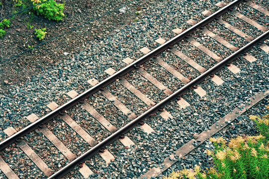 High angle diagonal view of railway tracks and gravel ballast in Oslo, Norway. Train track infrastructure, travel concept and background.