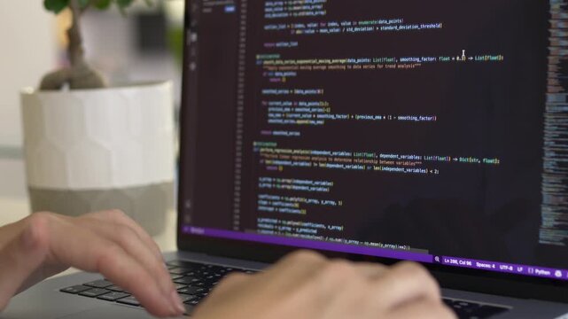 Developer interacting with command line code on laptop screen. Vibe coding, AI assisted programming and modern software engineering workflow concept.