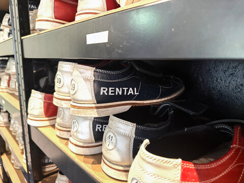Organized bowling shoes on storage shelves