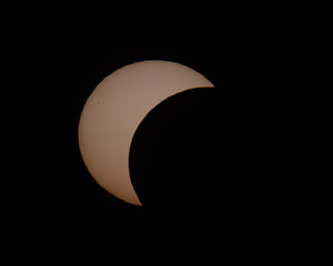 Partial solar eclipse phase with crescent sun against dark background © Veljko Klarić