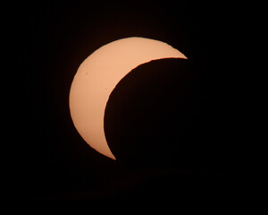 Partial solar eclipse phase with crescent sun against dark background © Veljko Klarić