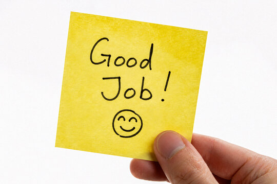 Hand Holding Yellow Sticky Note with Good Job Message