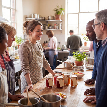 Woman teaching homemade preserves in a community kitchen class