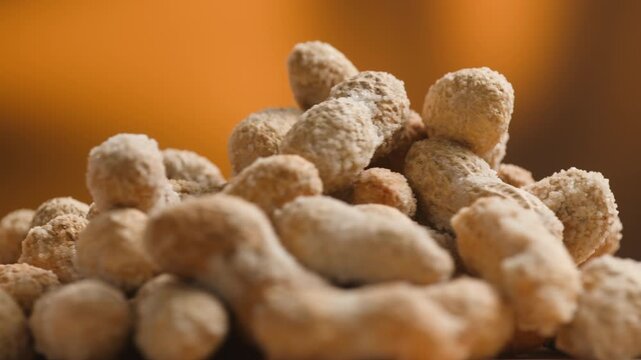 Peanuts in Salted Shell Man Cracking and Eating Salty Nuts as a Classic Bar Snack at Cafe