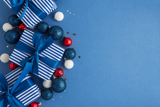 Striking Holiday Gifts Wrapped in Blue and White Stripes Adorned with Festive Ornaments and Sparkly Confetti