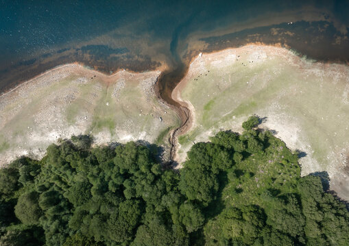 Low water levels in the Cray Reservoir in the Bannau Brycheiniog (Brecon Beacons) National Park in South Wales UK