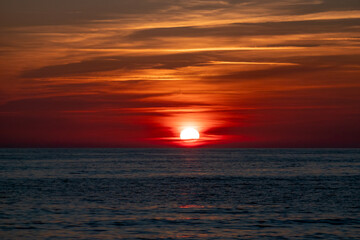 Fototapeta premium Sunset over calm ocean waves