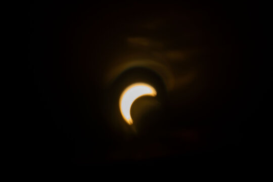 blurred partial solar eclipse glowing in dark sky, astronomical phenomenon, celestial alignment, moon crossing sun disc, stellar event, space science observation, Ghost cosmic mystery, orbital motion