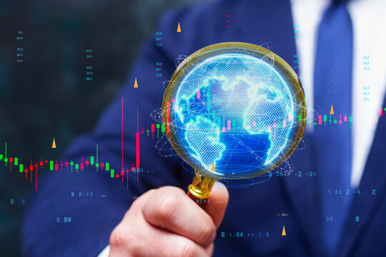Businessman holding a digital globe with global stock market candlestick charts and financial data overlays. International finance, investment, trading, market analysis and economic growth concept.