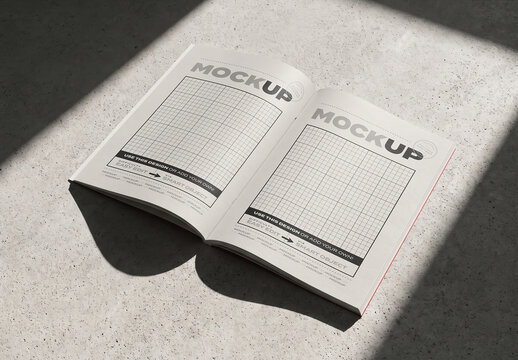 Open Pages Magazine Brochure on Concrete Surface