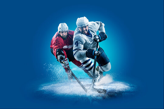 Hockey. Professional hockey player isolated on blue background. Hockey player in action. Hockey concept. Sport