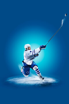Hockey. Professional hockey player isolated on blue background. Hockey player in action. Hockey concept. Sport