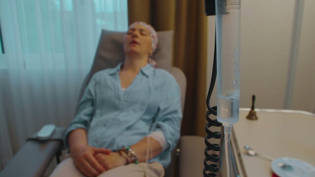 Intravenous therapy drip and female patient receiving medical treatment in healthcare center, dynamic focus transition emphasizing recovery, perseverance, healing and human resilience