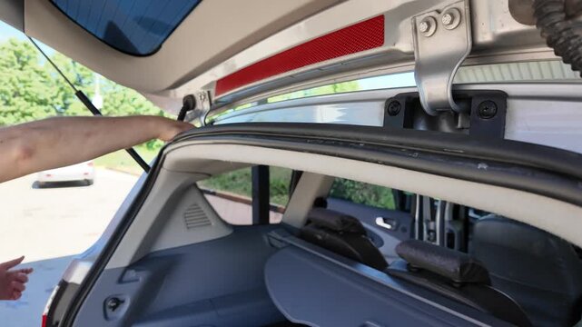 A man expertly cleans hard-to-reach areas of a vehicle during a sunny day. Using specialized tools, he makes sure every corner shines. Watch as he reveals hidden spots often missed at regular washes.