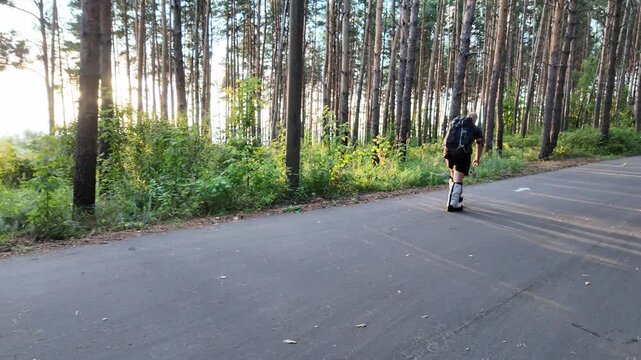 A man trains for mountaineering in a serene forest, burdened with a 50 kg backpack. With each step, he builds strength and endurance, connecting with nature as sunlight filters through trees.