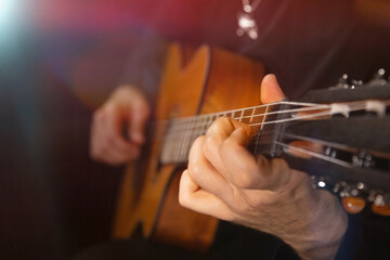 Fototapeta premium Guitarist Playing Acoustic Guitar on Black Background