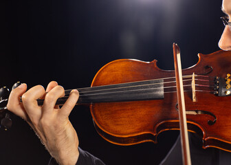 Violinist Playing Violin on Black Background © Lukas Gojda