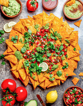 Nachos. Totopos with sauces. Mexican food concept. Yellow corn totopos chips with different sauces 