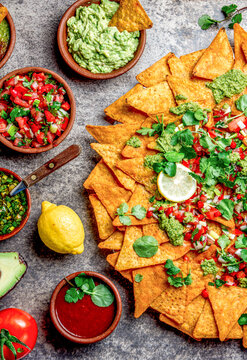 Nachos. Totopos with sauces. Mexican food concept. Yellow corn totopos chips with different sauces 
