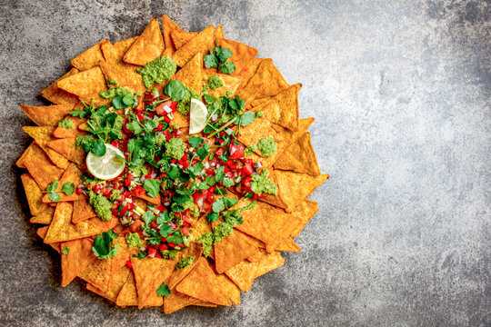 Nachos. Totopos with sauces. Mexican food concept. Yellow corn totopos chips with different sauces 