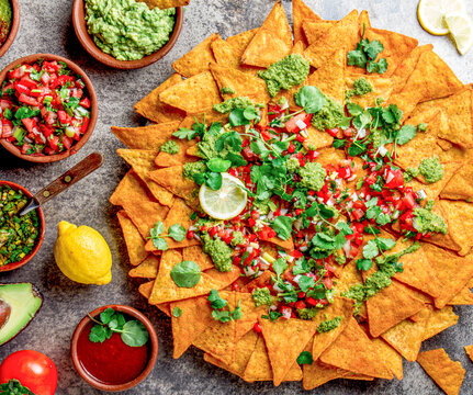 Nachos. Totopos with sauces. Mexican food concept. Yellow corn totopos chips with different sauces 