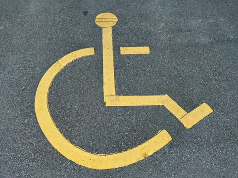 Close-up photo of a painted disabled sign, in the disabled parking space near the shopping mall
