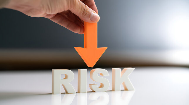 Human Hand Place Orange Down Arrow On White RISK Text For Business Decrease Financial Loss Control Concept