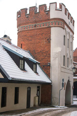 Bridge Gate (Brama Mostowa), topped with  battlement, frieze with painted tracery decoration. Toruń, Poland. © aerrant
