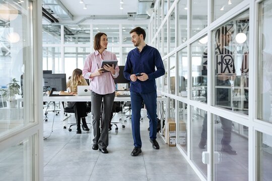 Diverse business team walking together during a collaborative office meeting