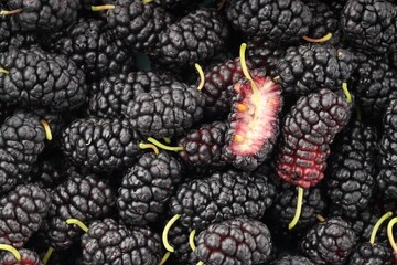 Many whole and cut mulberries as background, top view © New Africa