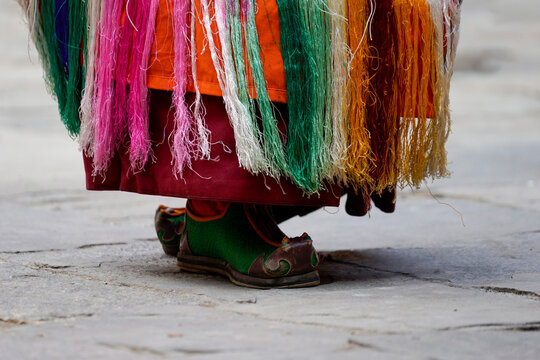 Bhutan in Bumthang, The traditional and handmade shoes of a monk in colourful costume dansing on the yearly festival in the monastery of Jakar.