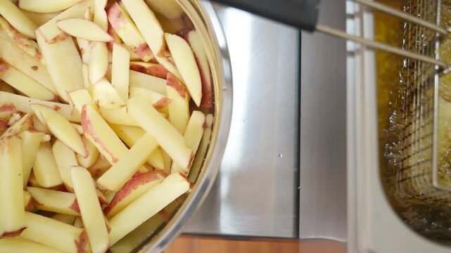 French fries cooking in a commercial deep fryer