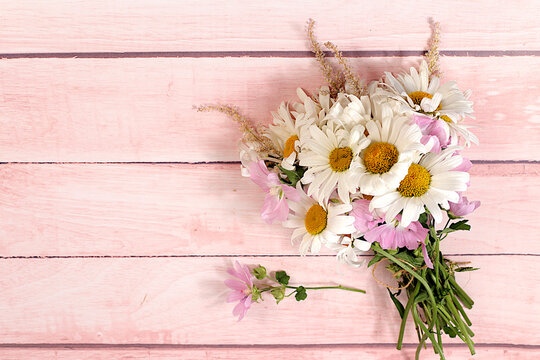 Bouquet of white daisies and mallow on wooden background, summer and autumn product advertising banner, abstract floral arrangement, flat lay still life, autumn holiday card with space for text