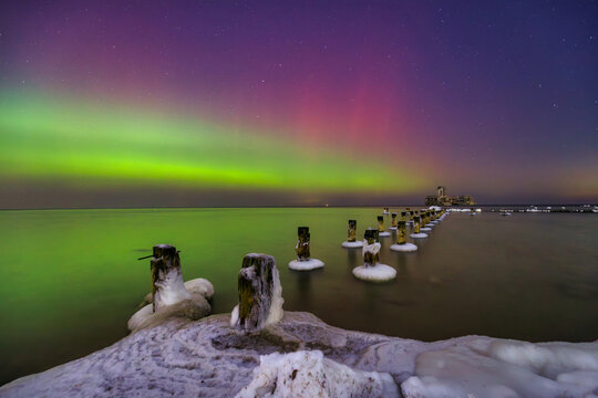 Baltic sea in Gdynia Babie Doly at winter night with northerm lights. Poland