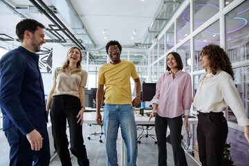 Fototapeta premium Diverse business team laughing together during a collaborative office meeting