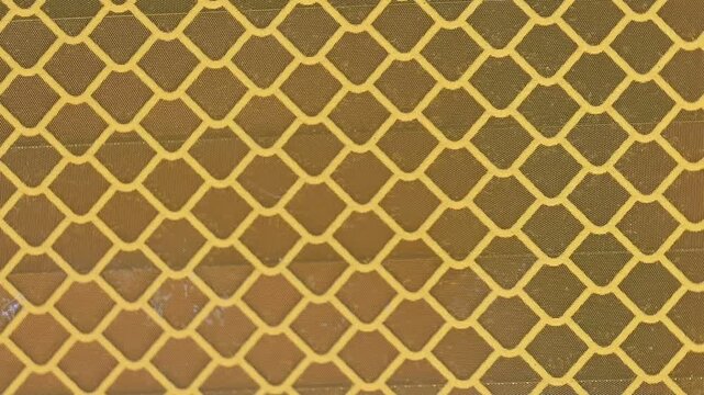 Yellow and Amber Reflective Safety Tape Patterns Close-Up
