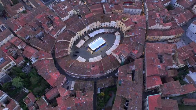 Aerial view of the main square, Piazza dell'Anfiteatro, in Lucca, night evening, Tuscany, Italy