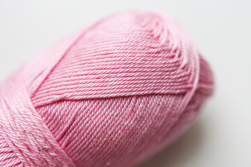 Fototapeta premium Pink yarn ball with twisted thread texture