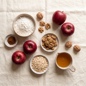 Flat lay of apple baking ingredients with flour oats honey and walnuts