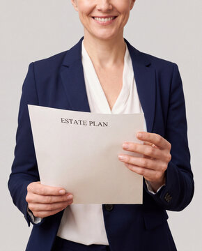 Smiling attorney holding an estate plan document on gray studio background